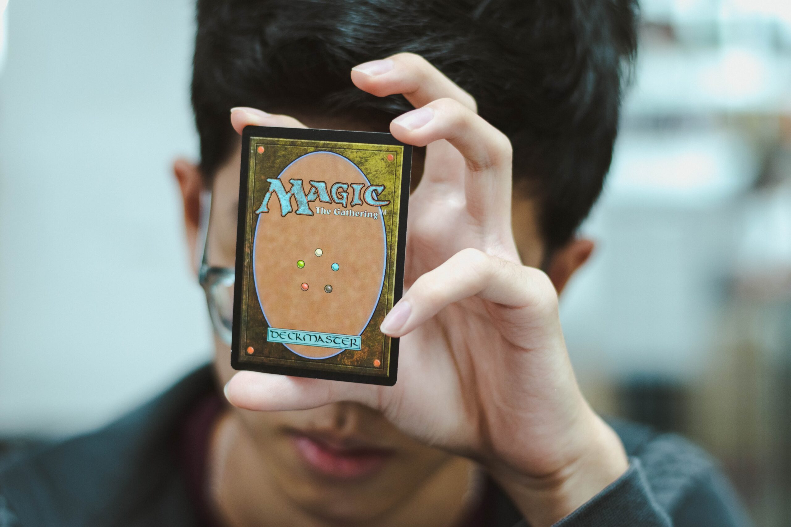 player holding a Magic: The Gathering card